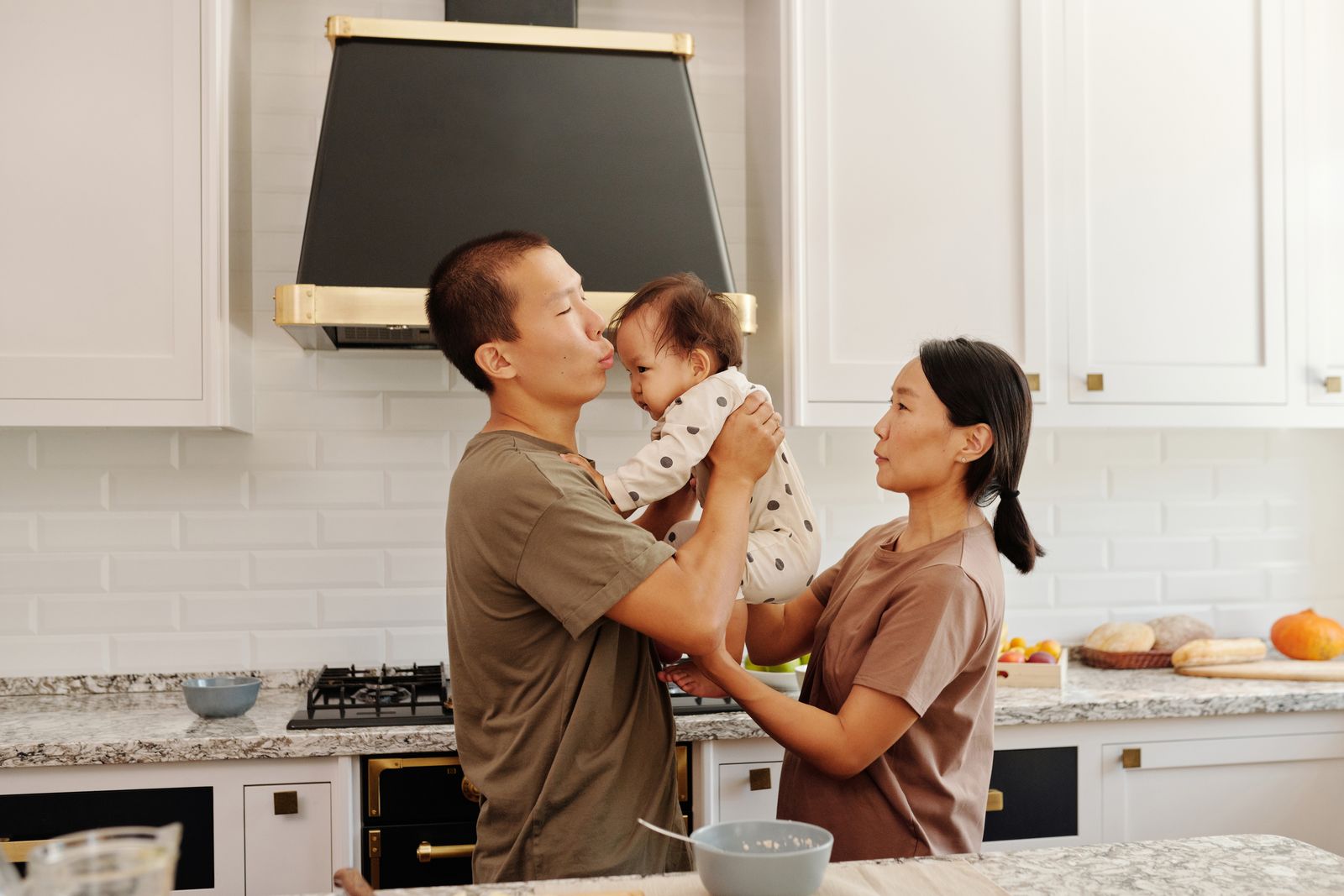 Parents sharing a tender moment with their baby at home