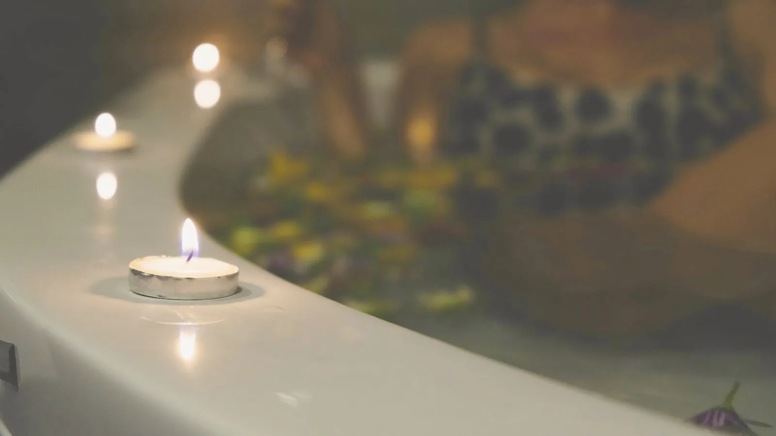 A candlelit bath with flower petals — a moment of calm